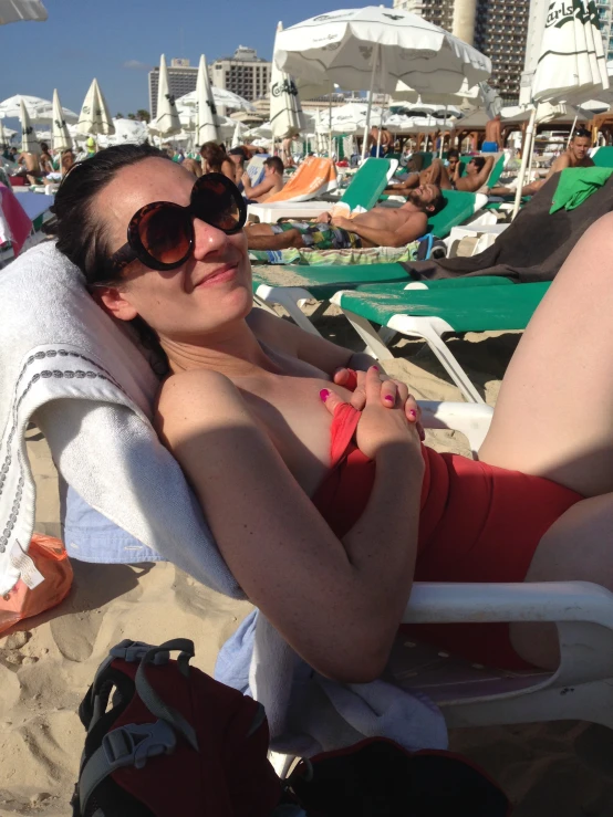 an image of woman laying on beach chair