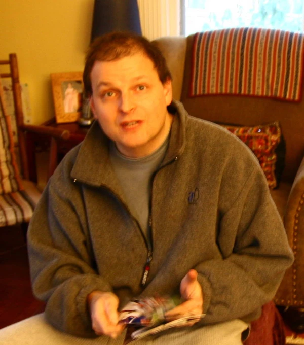 a man sitting down with a cell phone in hand