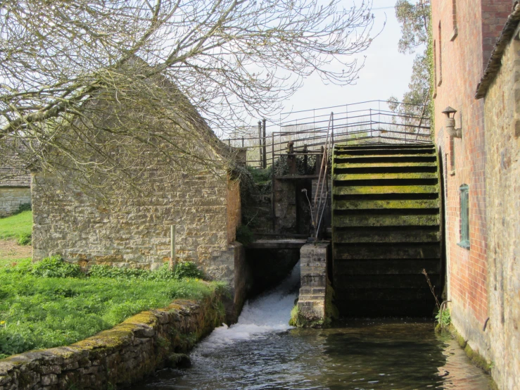 an entrance to the water source next to a grassy area