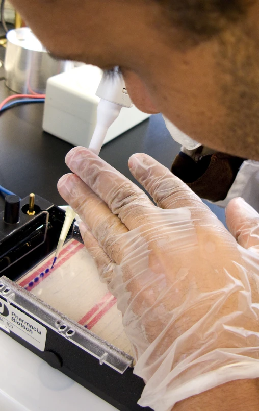 someone wearing a glove and gloves while removing their equipment