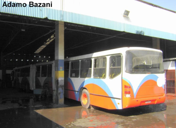 an older style bus is parked under a building