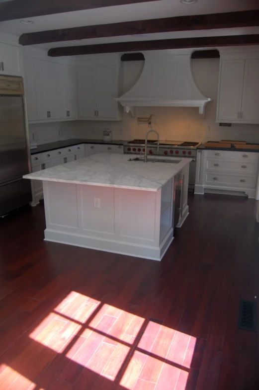 a large kitchen with two ovens and a center island