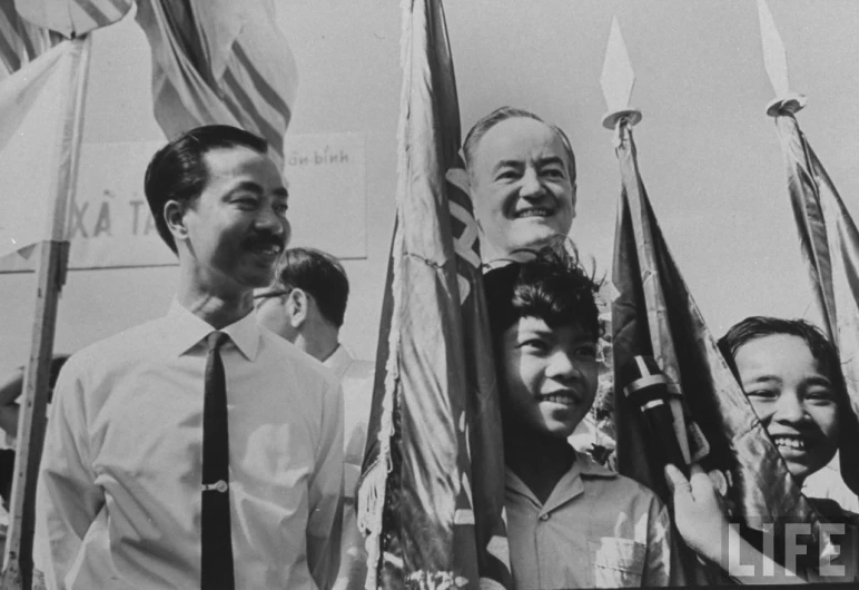 an old po shows men holding flags and smiling