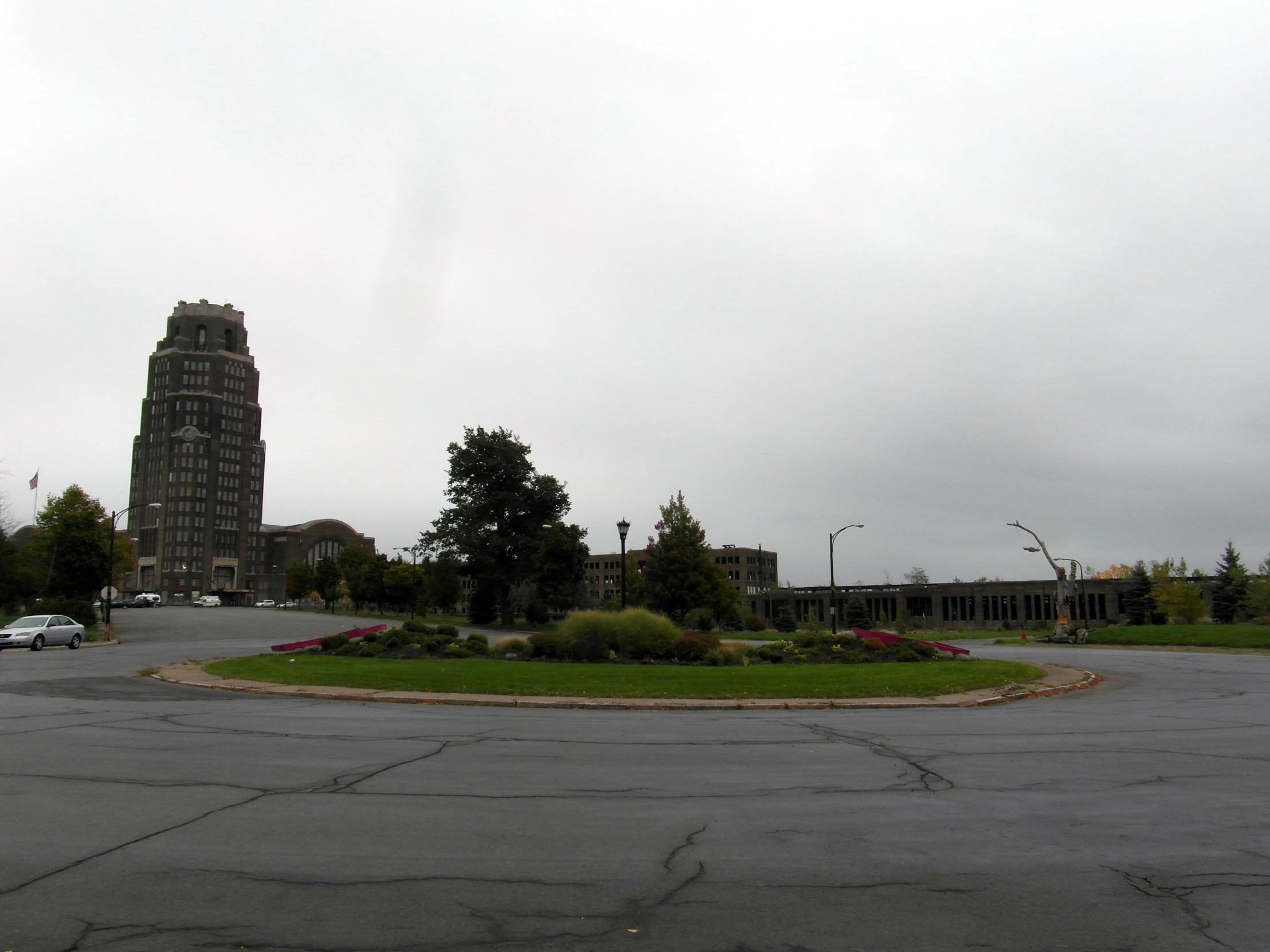 a parking lot with cars and a clock tower