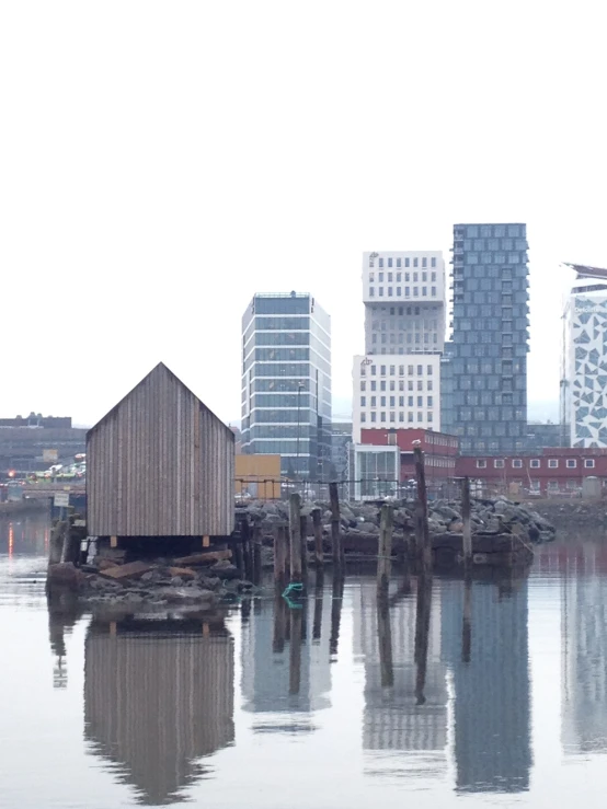 a small boat house sitting on a body of water