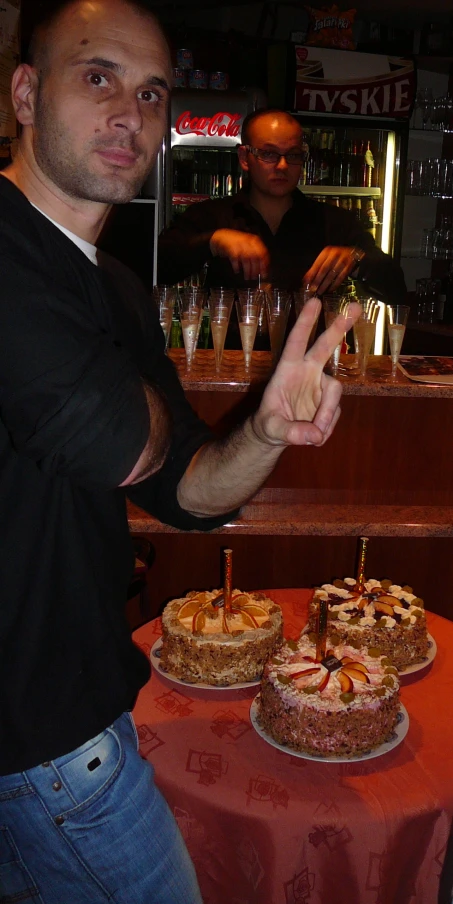 the young man is about to cut his cake