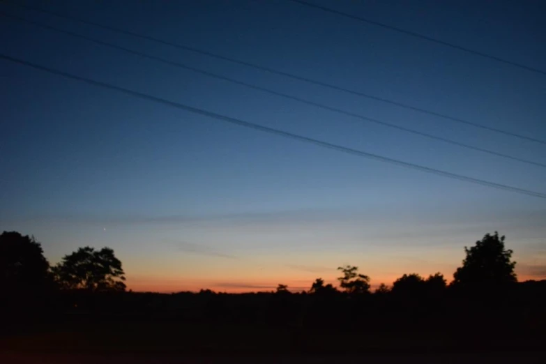 the sky at night with two lines of power in front