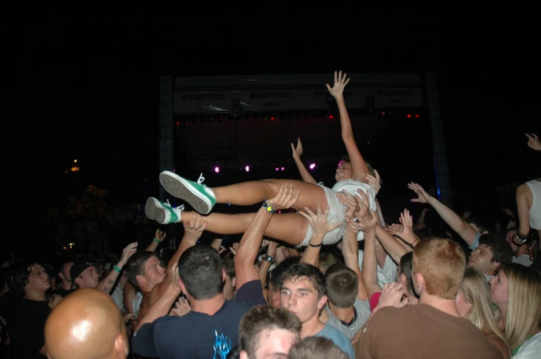 a crowd at a party is piled in the air