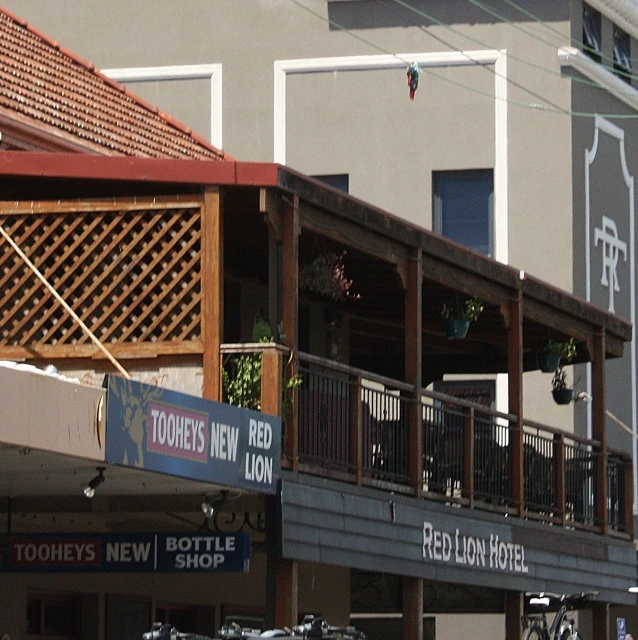 people walk down an urban street near shops