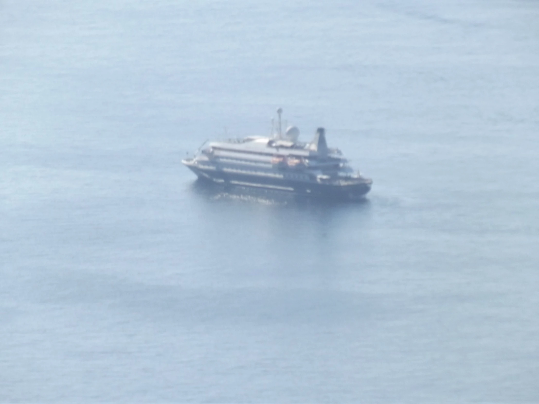 a boat is traveling in the middle of the ocean