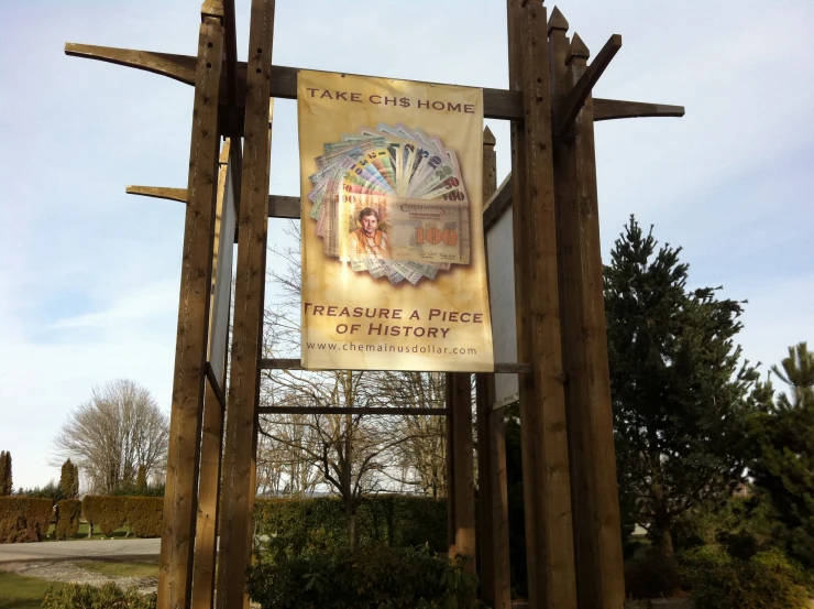 an advertit is hanging on the side of a wooden pole