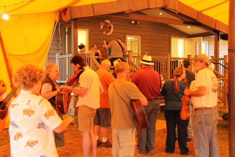 a group of people are around a house