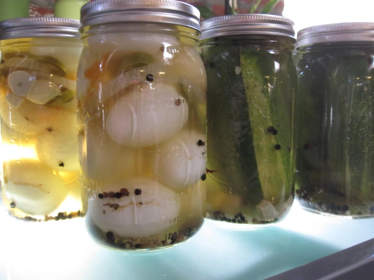 pickles are in mason jars lined up