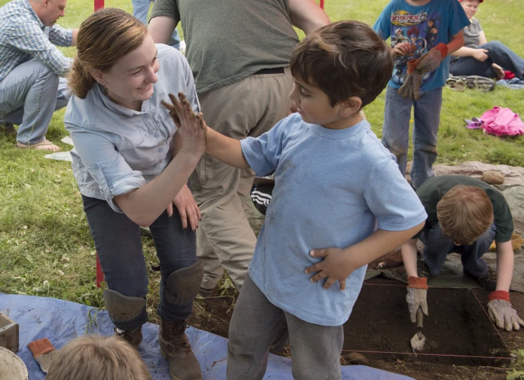 s gather around the young man while playing in the field