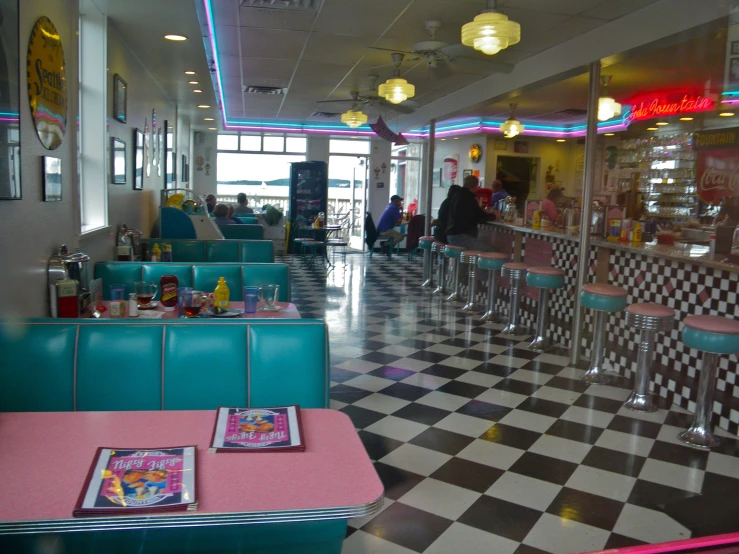 a diner's checkered floor and tables in an american diner