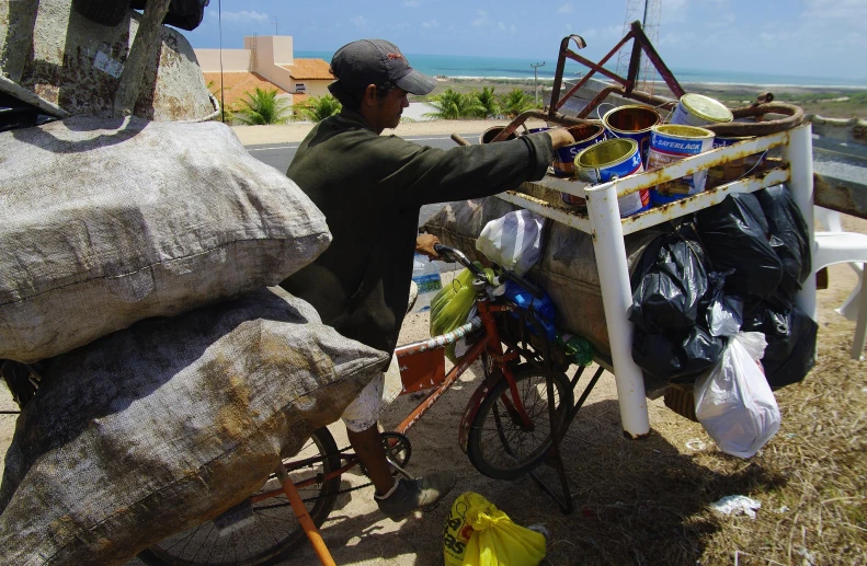 a man is selling items off a bike on the street