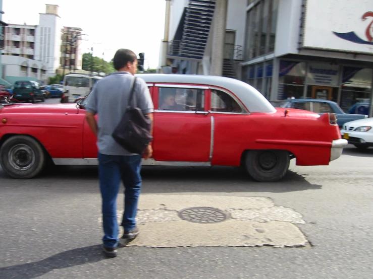 a man is waiting at a red taxi stop