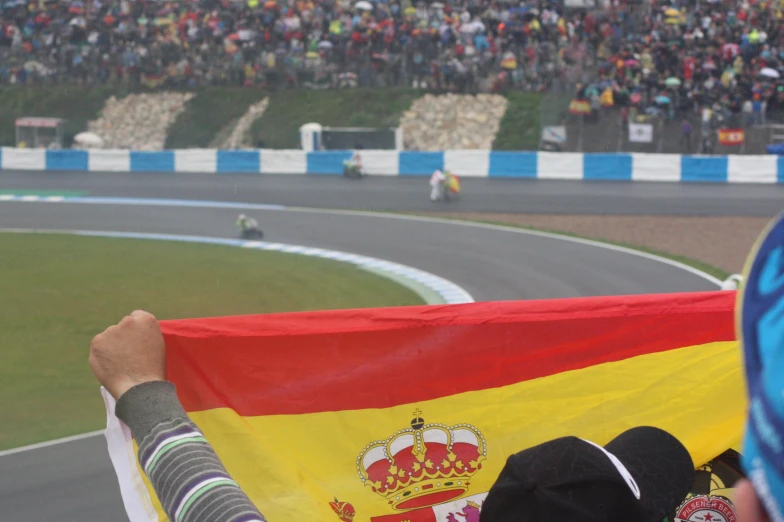 a crowd watches the racers on a race track