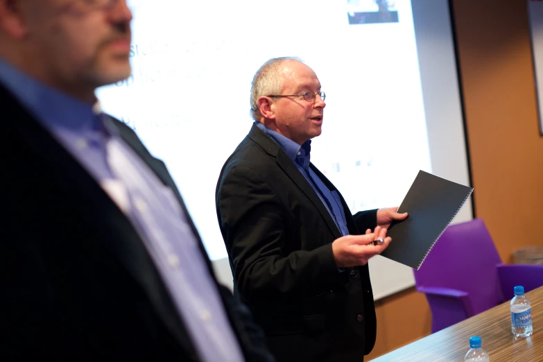 a man giving a lecture to some people