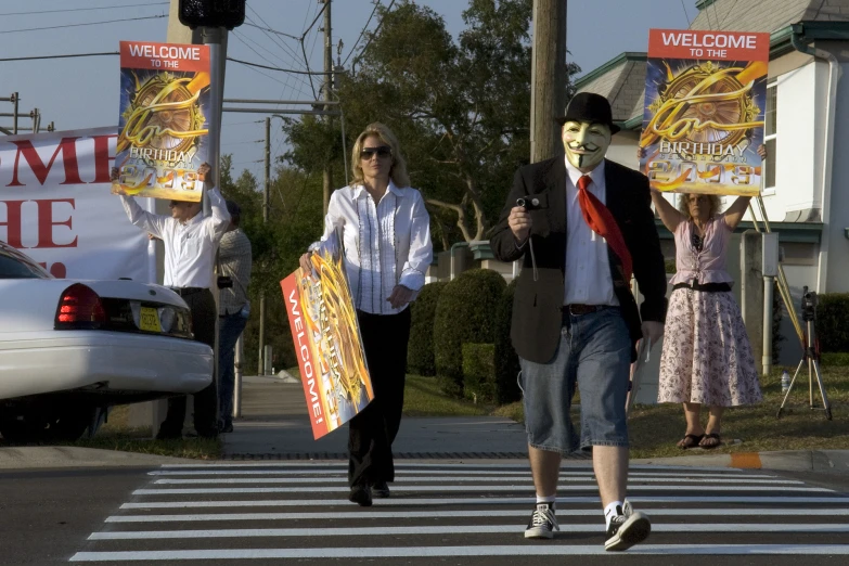 a man walks down the street in front of two people