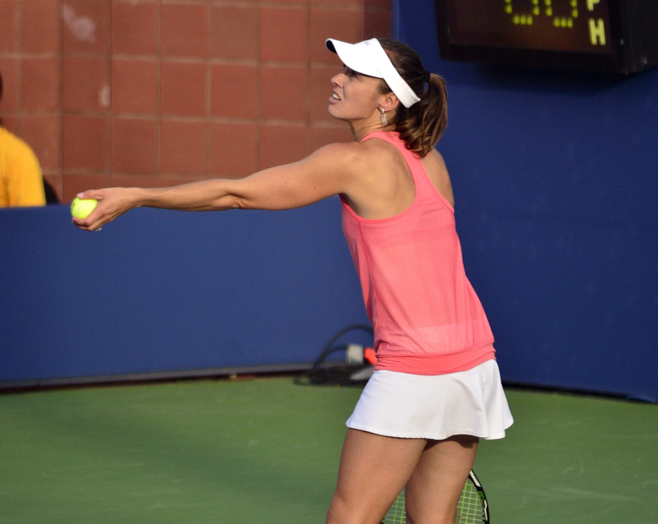 female tennis player serving during match on grass court