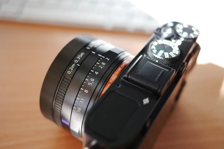 an analog camera sits atop a wooden surface