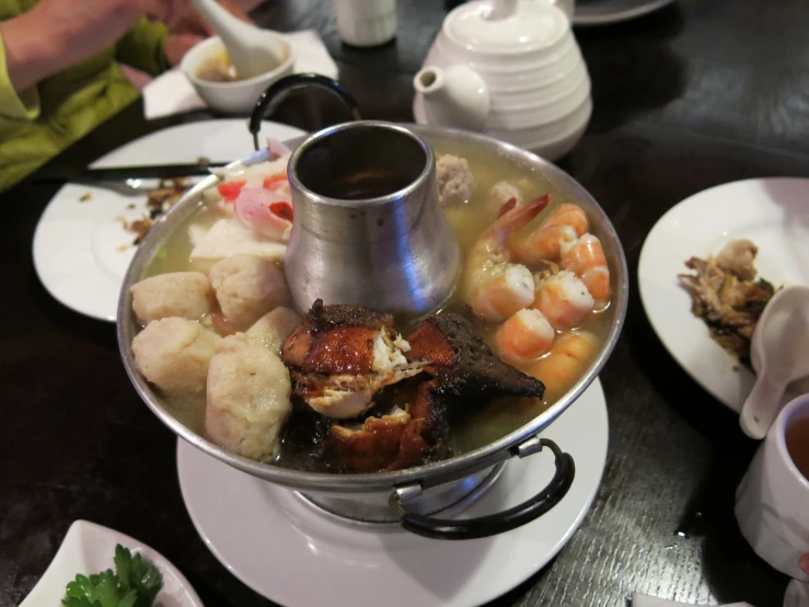 a large metal pan filled with seafood and shrimp