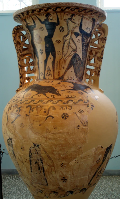 a vase is adorned with native painting on it