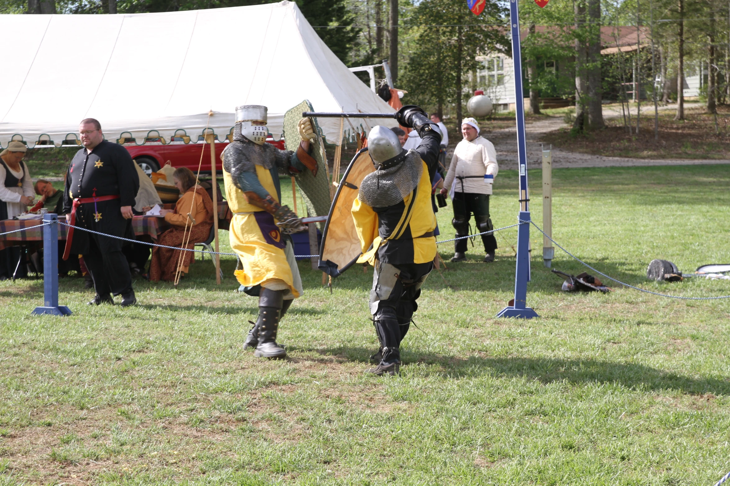 people in medieval garb playing battle outside