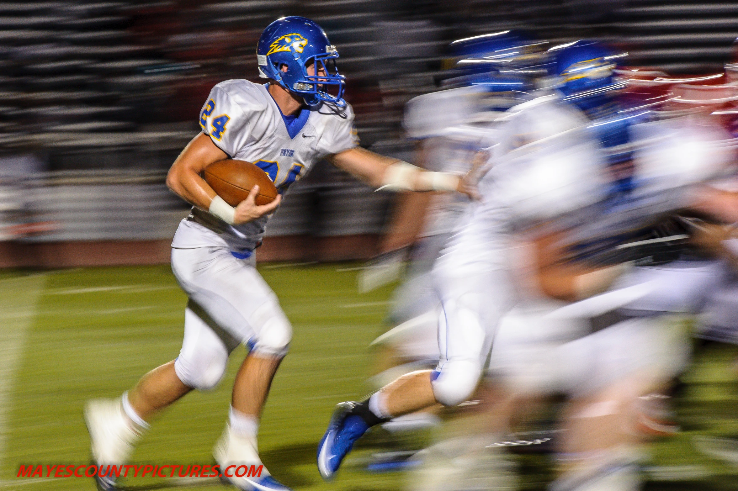 a running football player, moving forward with the ball