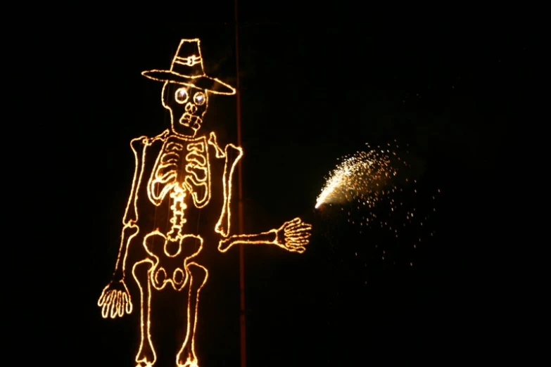 a large lit up skeleton wearing a hat