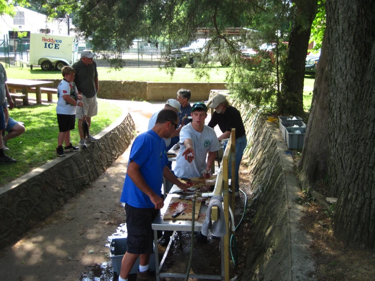 people standing around with food on a table