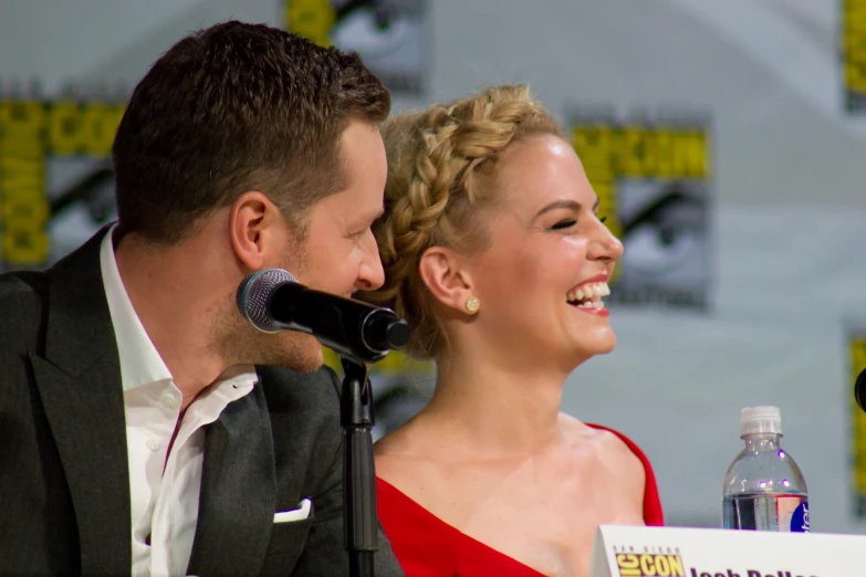 two people sitting at a panel with drinks