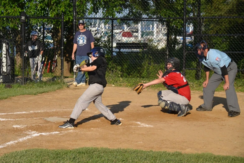 a batter and catcher waiting for the pitch