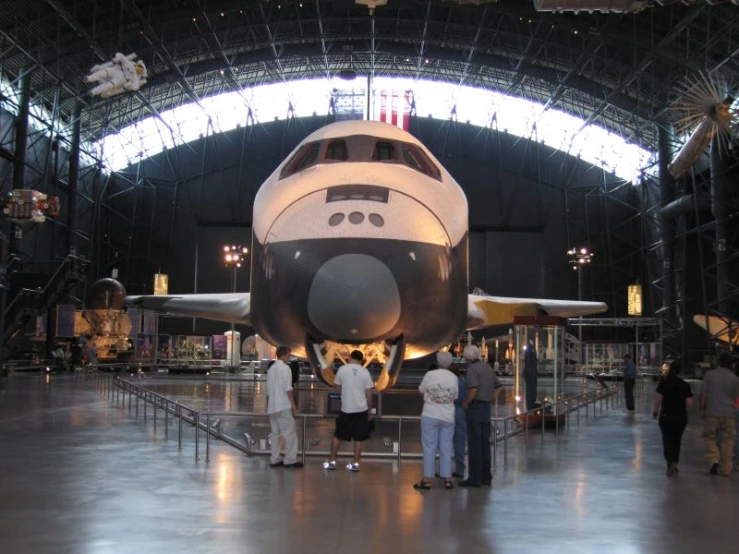 people standing around an airplane at the space museum