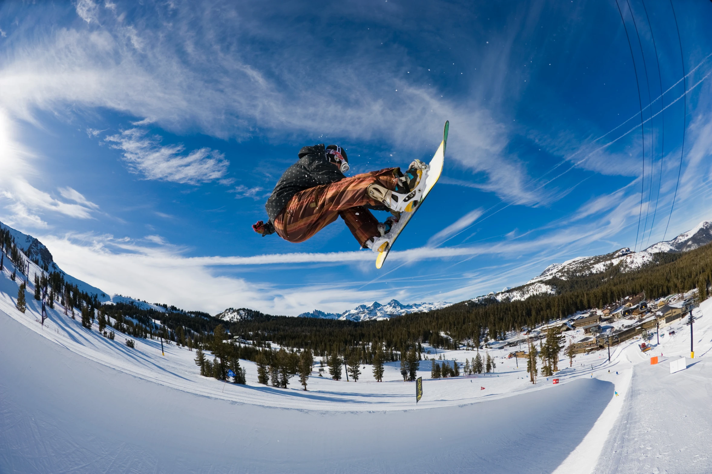 a snow boarder high in the air doing a trick