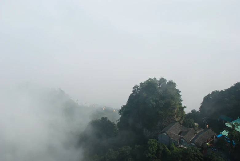 an overhead view of houses on a foggy day