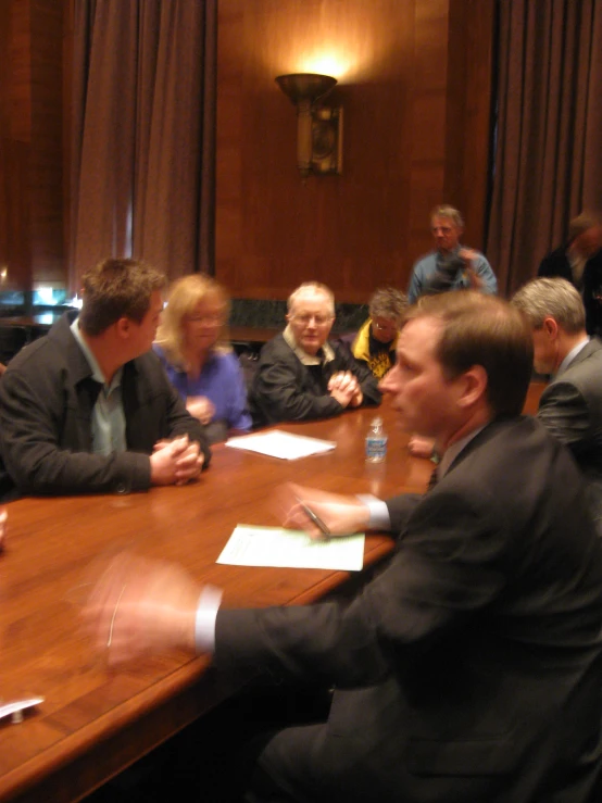 an image of a group of men and women at a conference