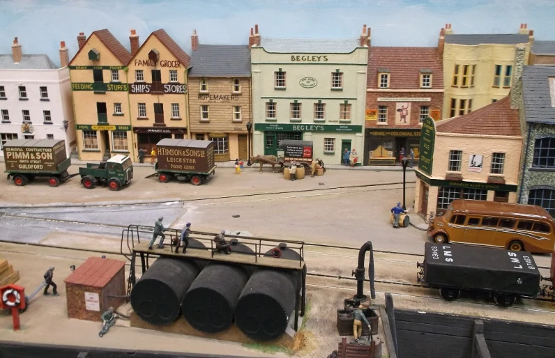 a model of a town with several buildings, vehicles and trucks