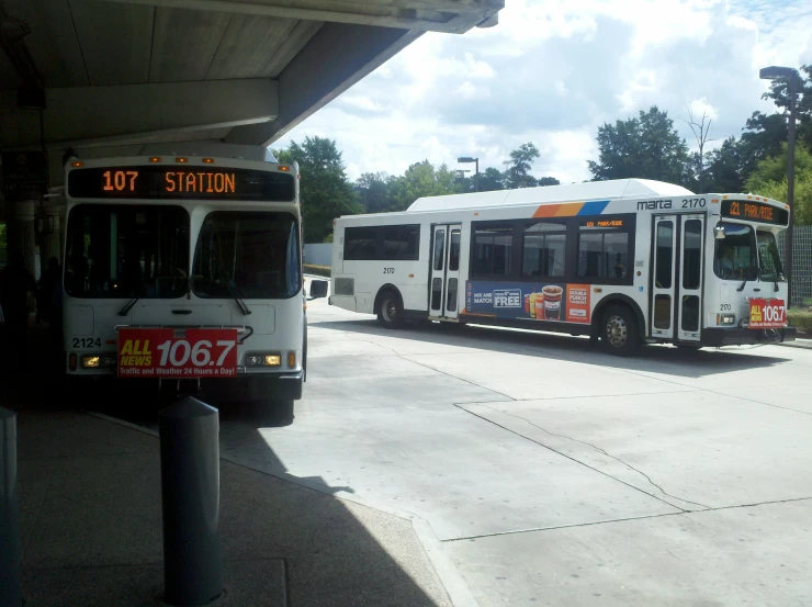 the city bus is parked by the side of the curb