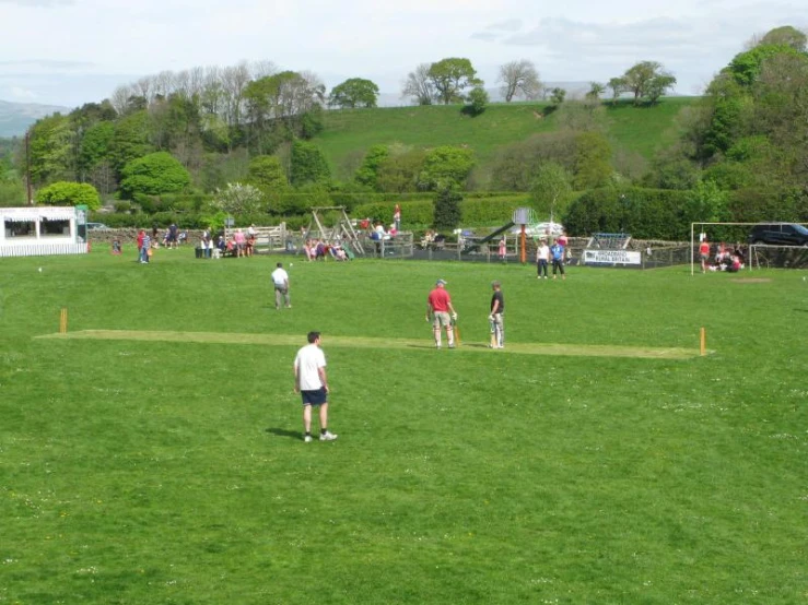 there is a man that is standing on a green field