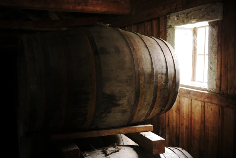 a large wooden barrel sitting in a room