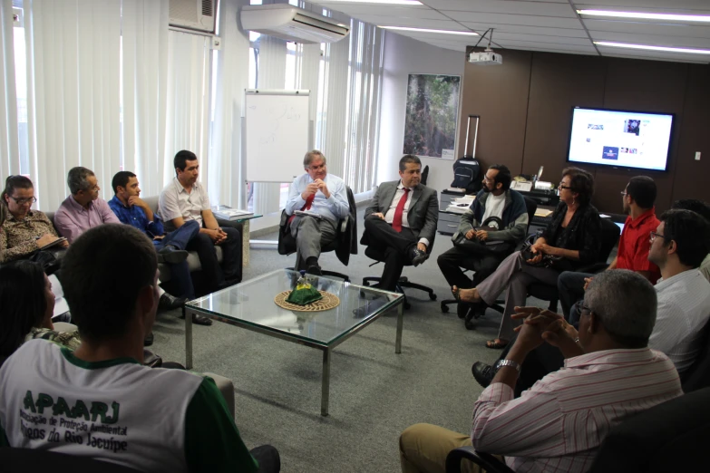 group of people having conversation in an office setting