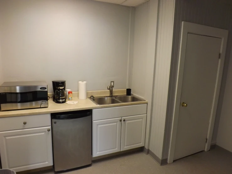 a kitchen with a sink a refrigerator and dishwasher