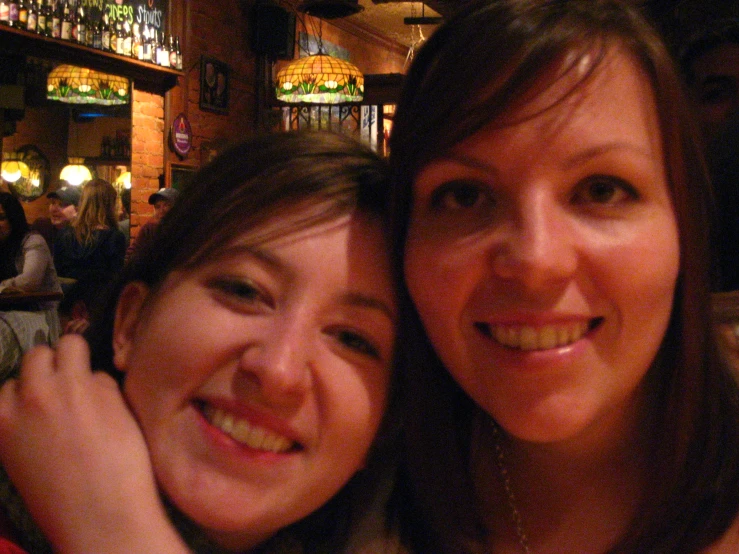 two women pose for the camera with their arms around each other