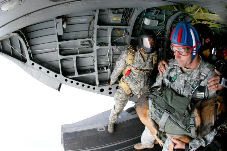 military man with military gear next to large object