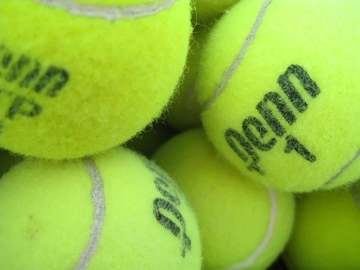 a close up of several yellow tennis balls