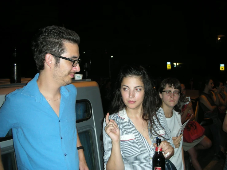 a man and woman standing near each other while talking