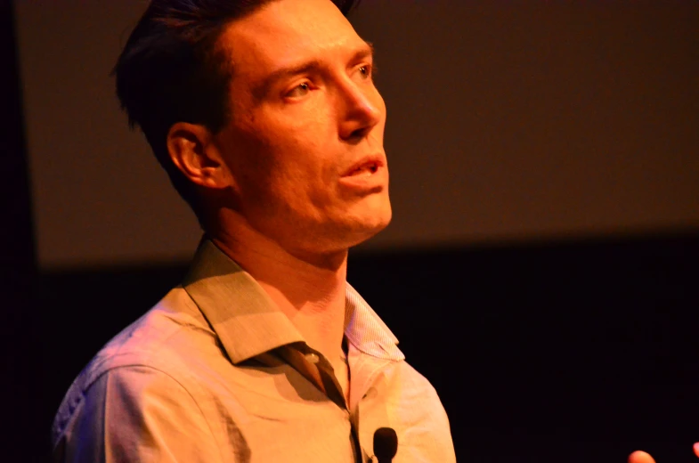 a man in a shirt is giving a speech