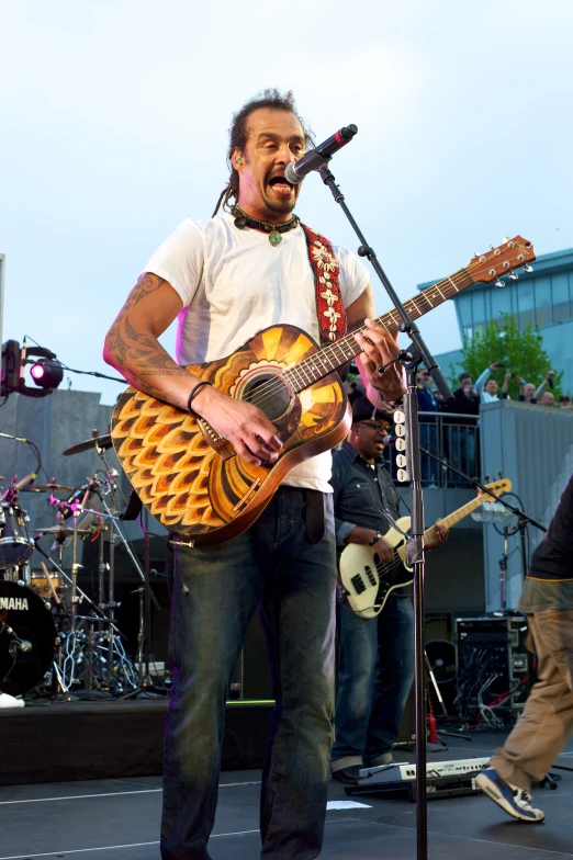 a man playing a guitar at the concert